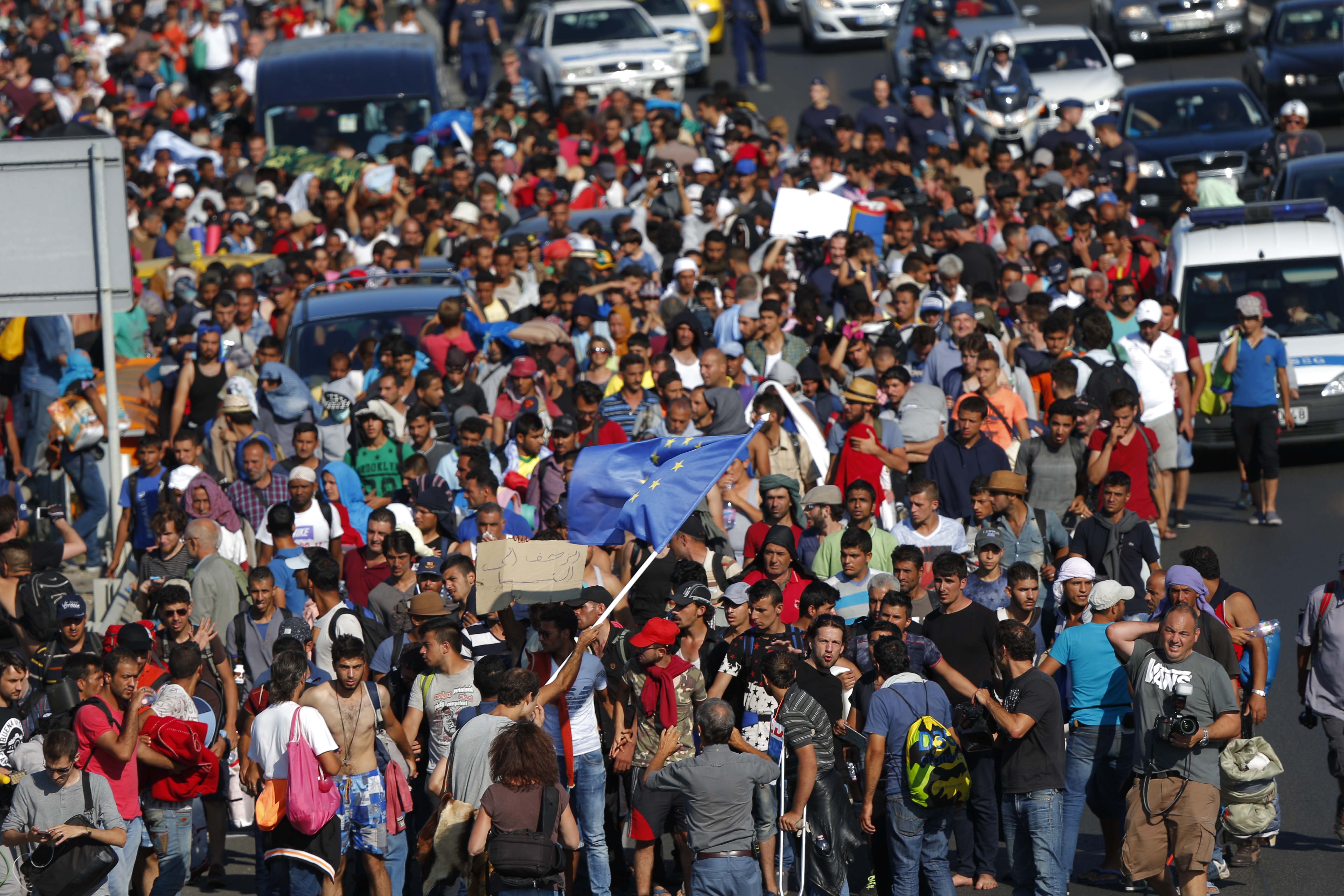 Migrants march along highway out of Budapest for the border with Austria 