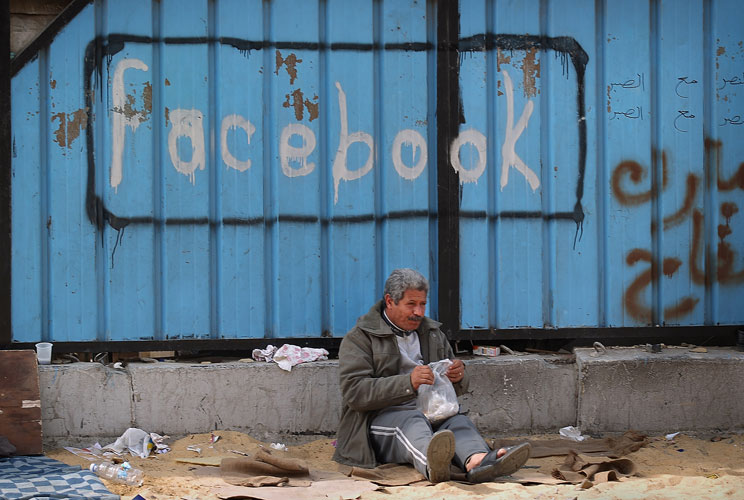 A fence is spray painted with the word Facebook in Tahrir Square on February 4, 2011 in Cairo, Egypt. Anti-government protesters called it 'The day of departure'. Thousands have again gathered in Tahrir Square calling for Egyptian President Hosni Mubarak
